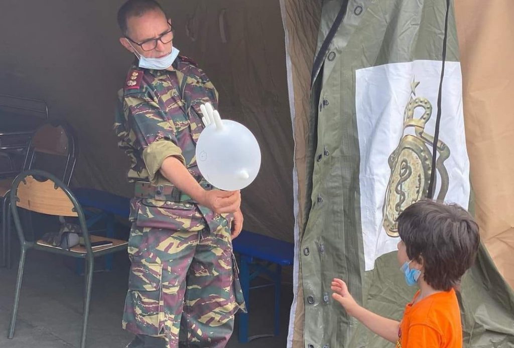 Moroccan Military Doctor Gives hand glove balloon to Lebanese Child