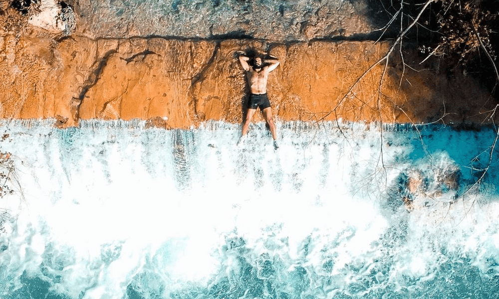 Meet lebanon's real life tarzan thestrollingtarzan on edge of waterfall in lebanon