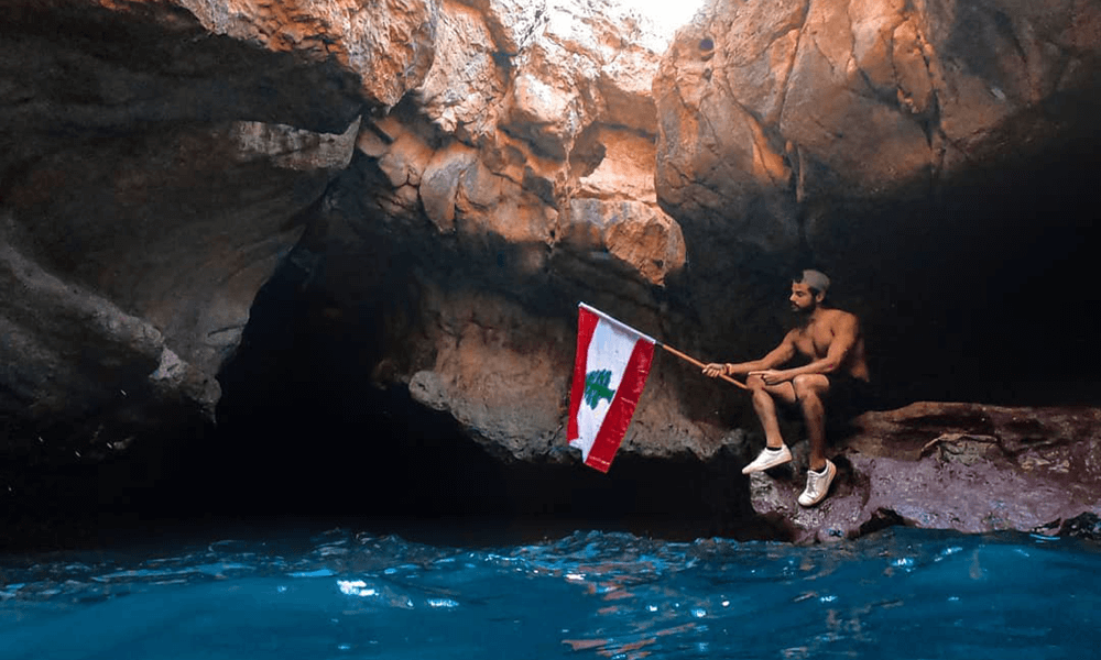 Meet lebanon's real life lebanese tarzan thestrollingtarzan holding lebanese flag