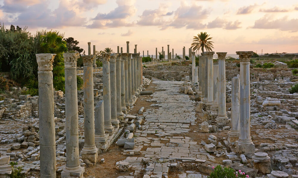 Sunset over the previously discovered ancient Roman road leading to the Phoenician harbor in Tyre, Lebanon